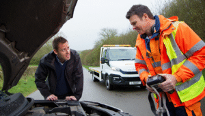 recovery services checking a broken down car