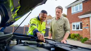 Technician explaining battery replacement after repeated jump starts.