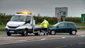 Flatbed recovery truck helping a broken down car on the M20 near Ashford.
